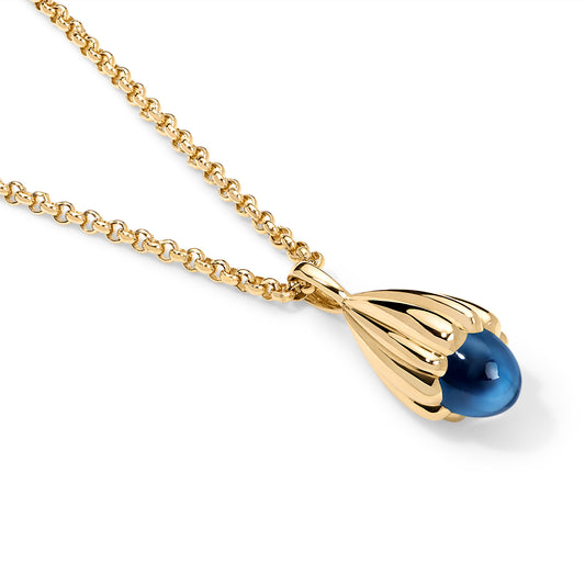 A gold chain necklace with a teardrop-shaped pendant featuring a polished blue cabochon stone, shown on a clean white background.