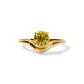 Gold ring with with a soft wave contour holding a yellow colored gemstone