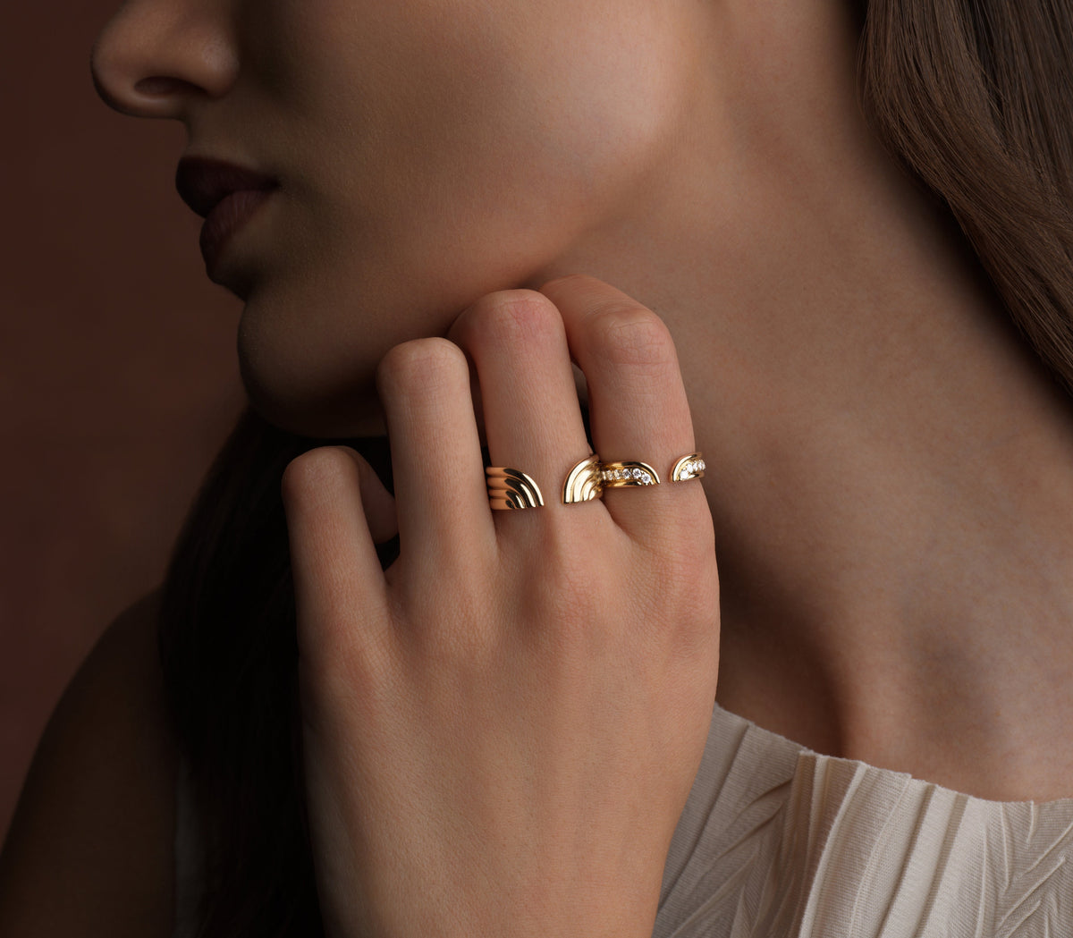 close up lifestyle photo of a model wearing two gold rings.